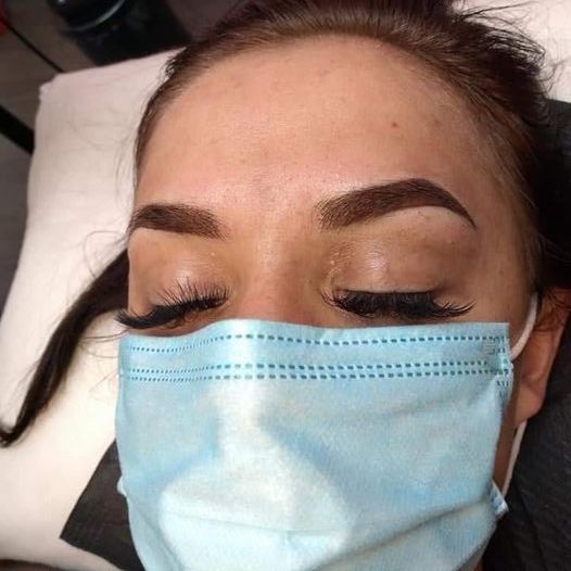 Client resting after a combo brow procedure in the LaBrows studio